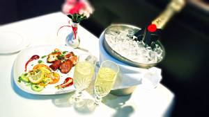 Indian Empire table laid with cutlery, champagne and fine food thumbnail